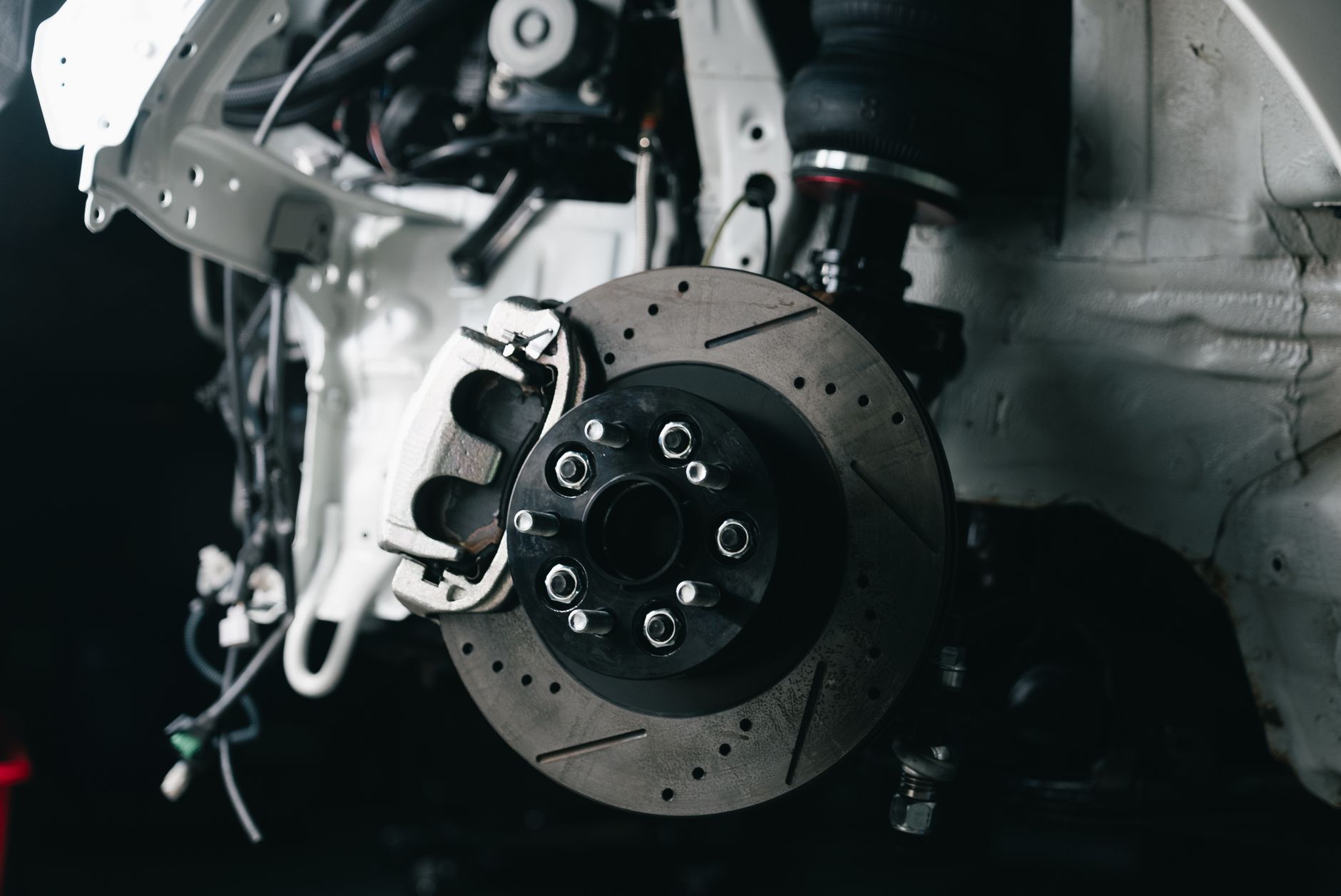 A brake disc and caliper on a vehicle, close up